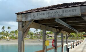 Resort signs executed in sandblasted solid surfacing with bronze accents that pick up the colors of weathered wood and volcanic beach sands.